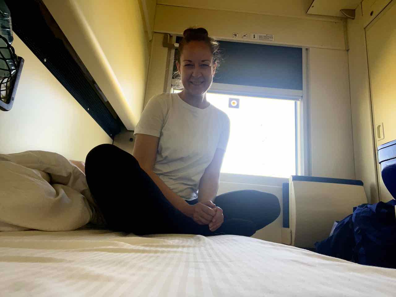 Zugfräulein auf dem Bett sitzend im Nachtzug nach München von Krakau